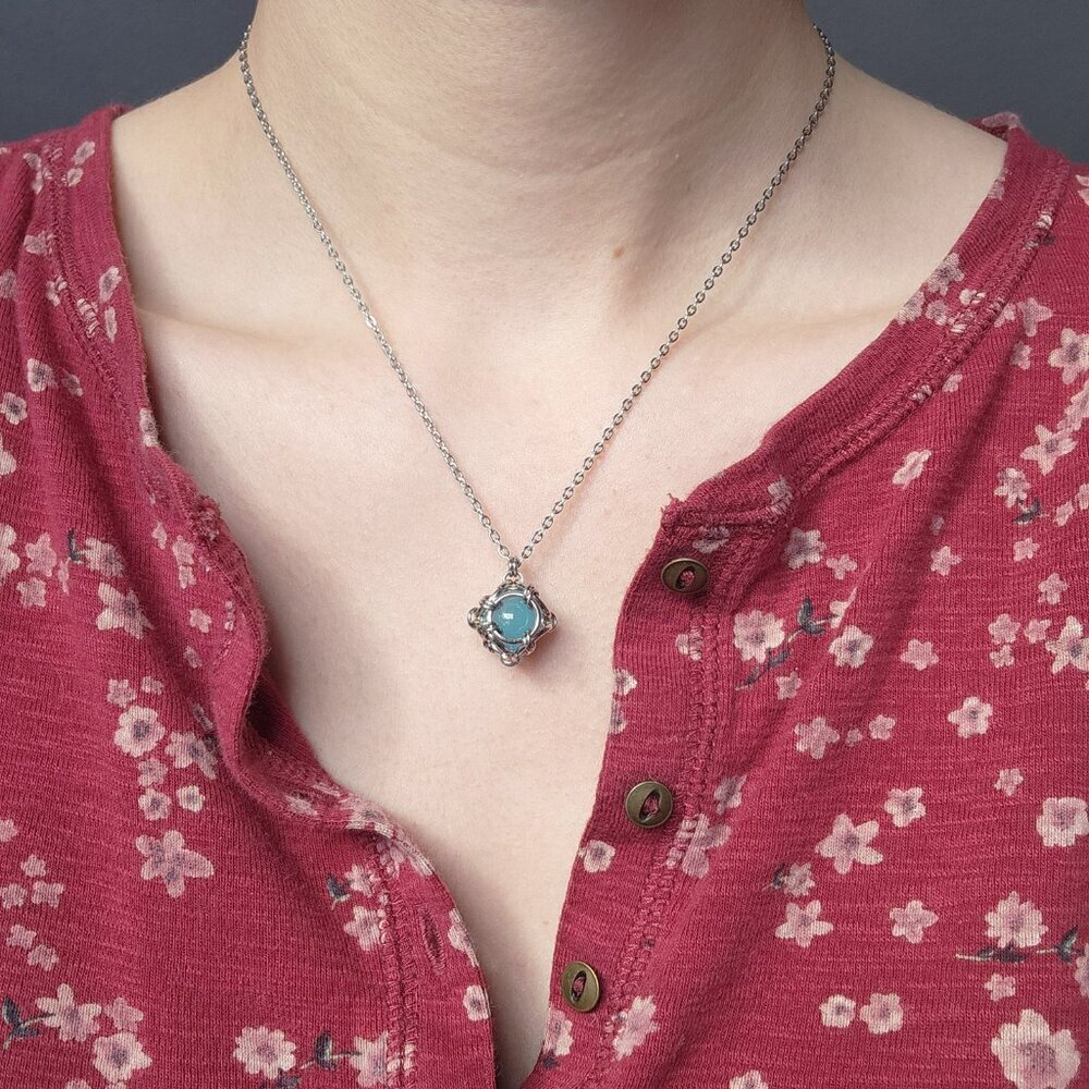 Aquamarine blue caged pearl necklace with a small silver chain